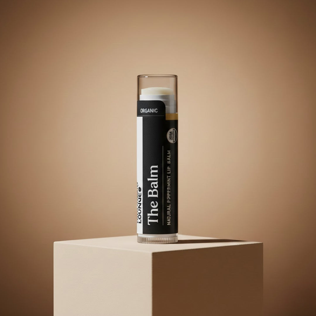 Lip balm with 'The Balm' branding on a beige background