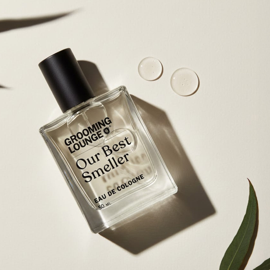 Perfume bottle labeled 'Grooming Lounge Our Best Smeller' on a light background