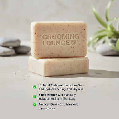 Two bars of Grooming Lounge soap on a neutral background with product details.