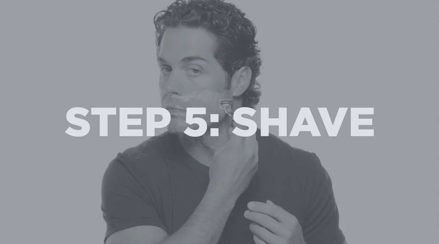 man shaving his face